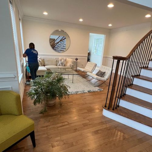 Cleaner dusting furniture Cleaner dusting furniture in a modern room with top cleaning services in Boston.